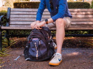 Man looking through a backpack