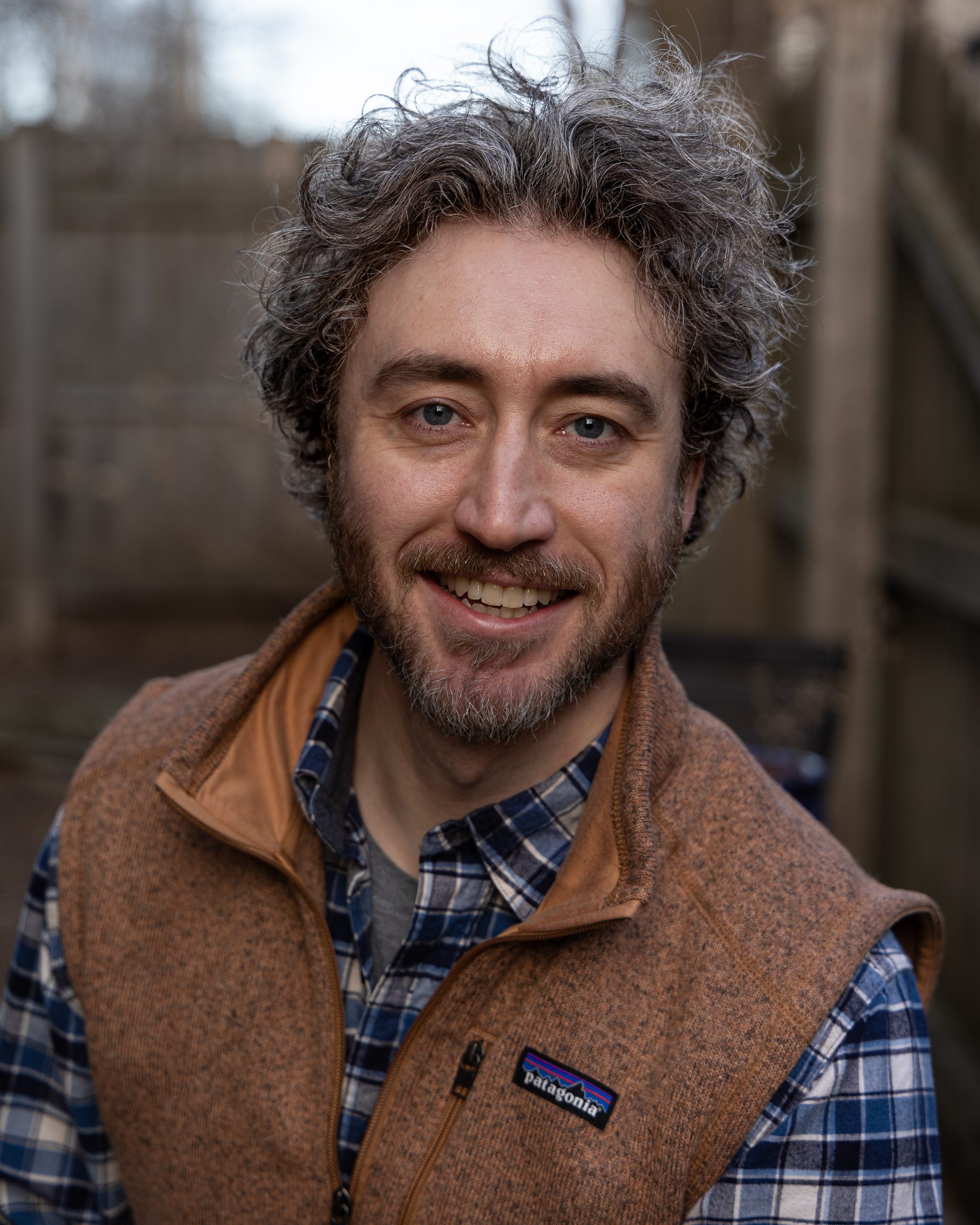 Tim wearing a brown vest outdoors